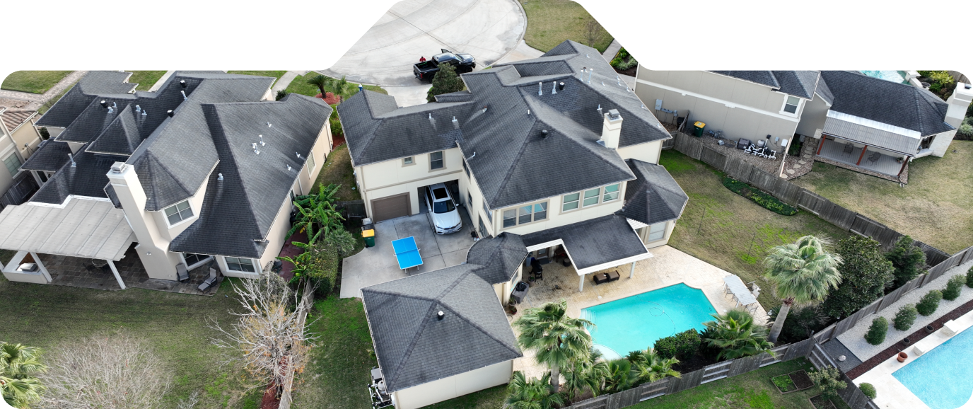 Large homes with gray shingle roofs.